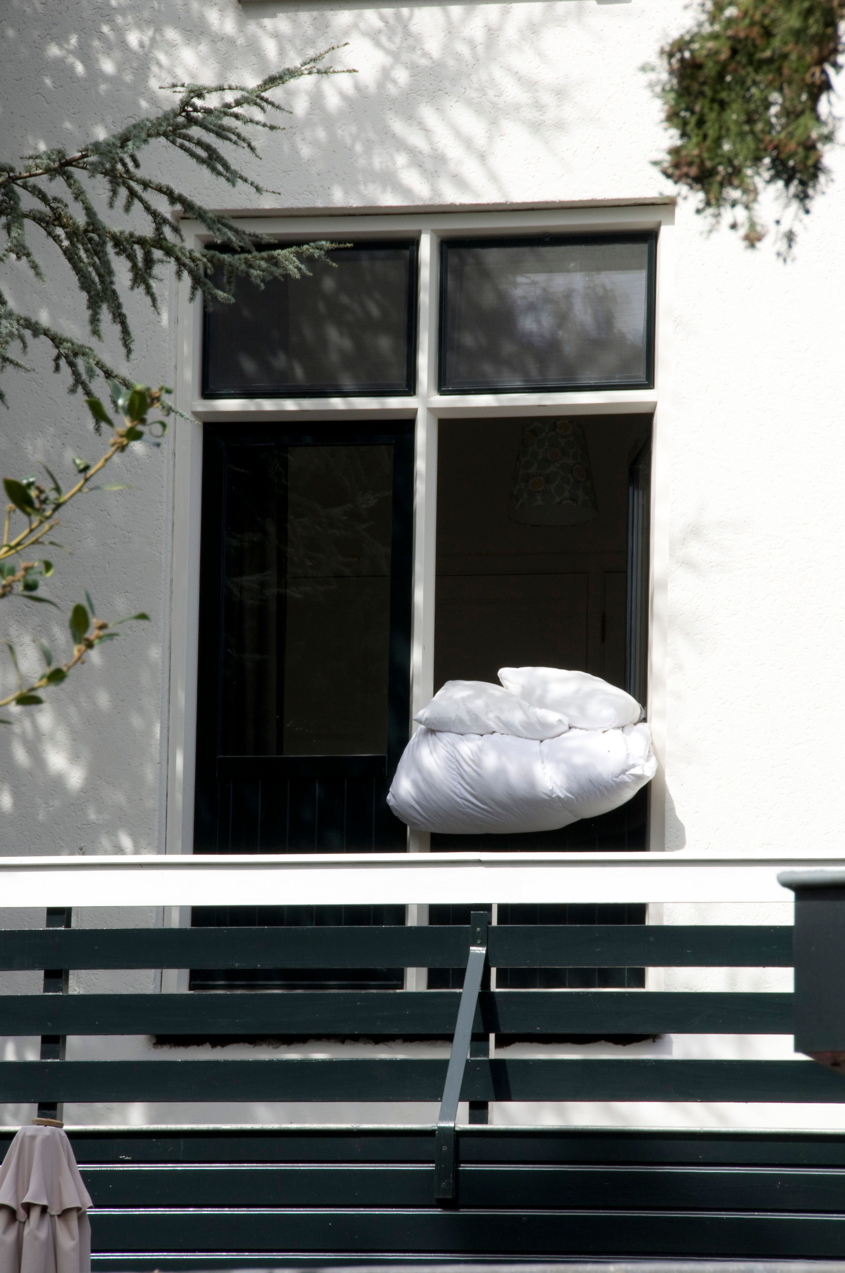 Fresh pillow and duvet airing outside in bright natural light