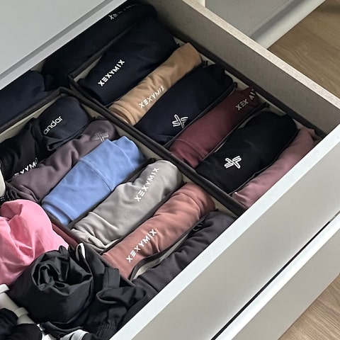 Neatly organised activewear folded in a wardrobe drawer