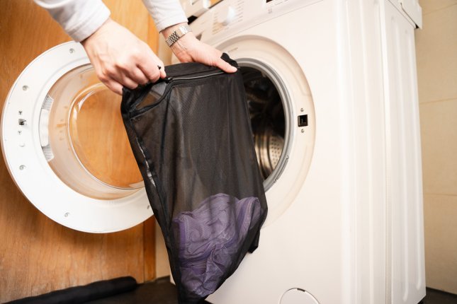 Premium technical cycling apparel protected inside a mesh laundry bag before washing