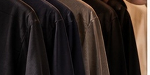 Dark wool and tailored garments hanging on a rail