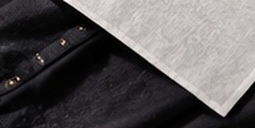 A white press cloth laid over a dark shirt
